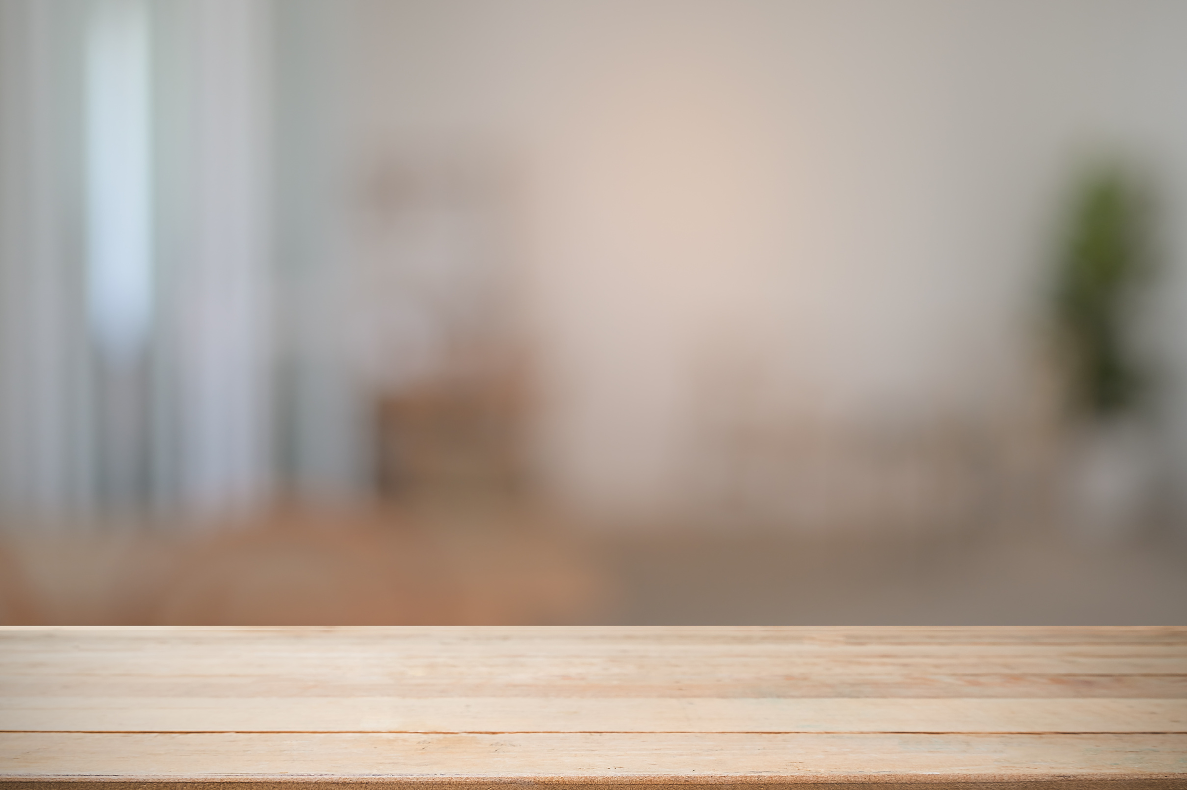 Montage wooden desk with blur room background.